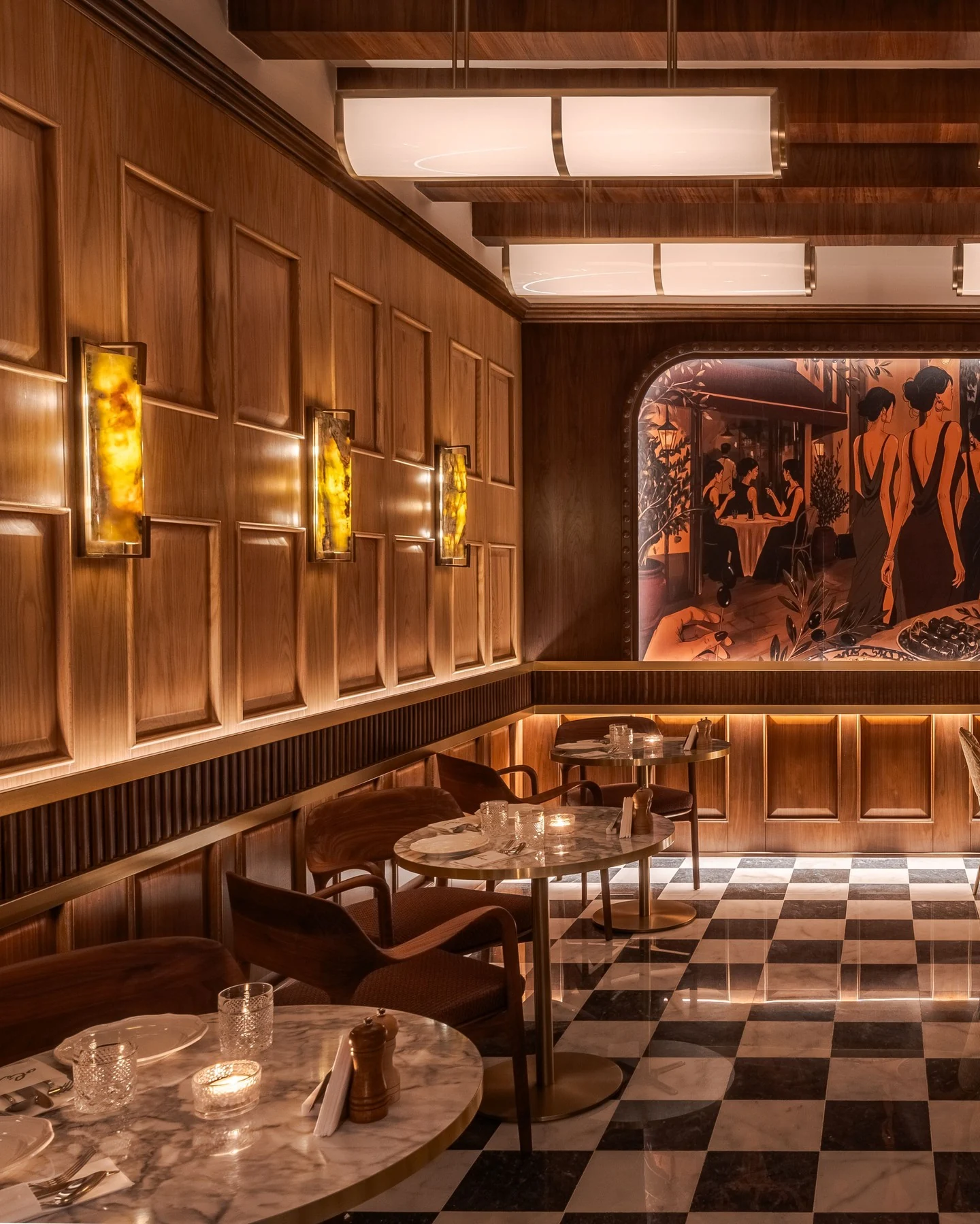 OLEV’s warm wood-paneled dining room, illustrated mural and checkerboard floor