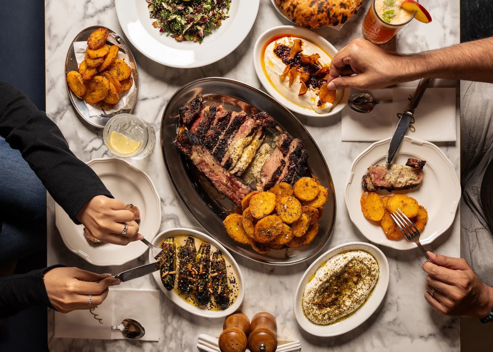 Breads, mezze and grilled meat shared at the OLEV table